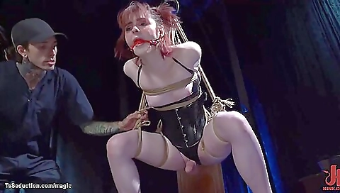 Ginger blonde gets stuck in a red bondage gagging device