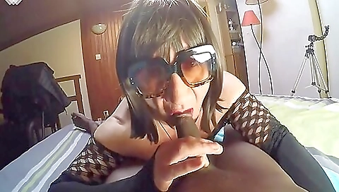 Ebony chick wearing a lingerie and a skirt sucking a dick