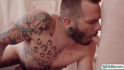 Sexy blonde in lingerie gives an oral massage to a guy